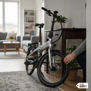A space-saving folding e-bike tucked away in a narrow hallway of a typical UK terraced house.