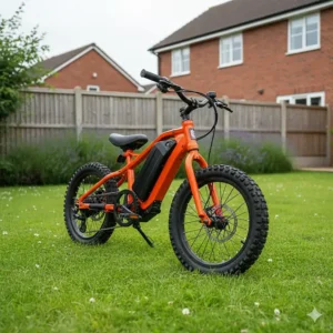 A lightweight kids electric bike standing on a green lawn in a typical British back garden.