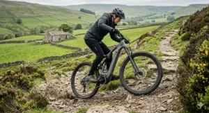 A 48V electric mountain bike demonstrating high torque and power while climbing a steep, rocky bridleway in the British countryside.