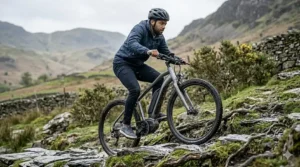 A rider tackling a technical, rocky ascent in the UK Highlands on an electric mountain bike with a high-precision torque sensor.