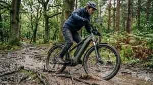 A 48v electric mountain bike navigating a muddy forest trail in the UK.