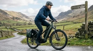 A cyclist effortlessly riding a powerful 48v ebike up a steep British countryside hill.