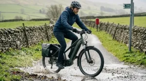 A powerful 48v ebike with mudguards riding through a puddle in typical British rainy weather.