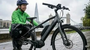 Close-up of an electric bike equipped with waterproof rear panniers and hydraulic disc brakes, ideal for wet-weather commuting in the UK.