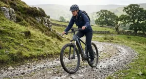 An electric mountain bike with front suspension navigating a gravel trail, showing off-road options for e-bikes between £1000 and £2000.