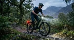 An electric mountain bike featuring a powerful built-in lighting system for evening trail riding in the UK countryside.