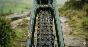 Alt text for an extreme close-up of the rear tyre and frame stays showing 27mm mud clearance and a technical decal for efficient peat shedding on UK trails.