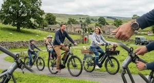 An infographic overlay on a countryside cycling scene comparing carbon emissions of petrol cars versus long-range electric bikes.