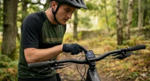 Rider checking the battery range display on their electric enduro bike.