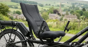 Close-up of the ergonomic, padded seat of an electric recumbent bike designed for long-distance comfort.