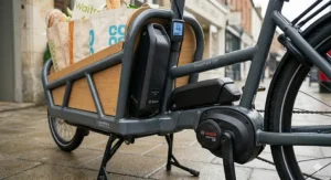 A person loading a cargo ebike with shopping, highlighting a sustainable alternative to using a car in the UK.