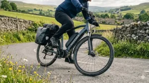 A professional riding an electric bike for their daily commute through a bustling UK city centre.