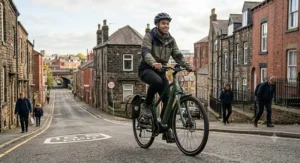 A rider effortlessly ascending a steep urban hill with powerful 250w pedal assistance engaged.