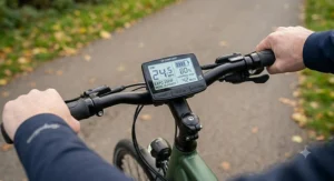 Close-up of the handlebar-mounted LCD console, showing battery life and assist level on an EAPC bike.