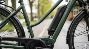 A detailed technical diagram of the dark green step-through ebike frame, illustrating how the internal mid-drive motor and battery integration work together for joint comfort.