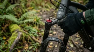 Front suspension fork on an electric XC bike showing preload adjustment.