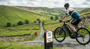 A commuter riding a mid-drive e-bike up a steep city street in the UK.