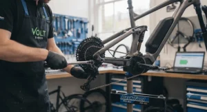 A technician performing a safety check on a 48v electric bike at a professional UK bike workshop.
