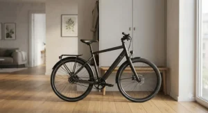 A compact belt drive commuter ebike stored neatly inside a modern city apartment hallway.