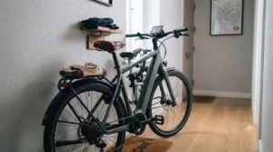 A space-saving, GPS-enabled commuter e-bike neatly stored in the hallway of a compact city flat.