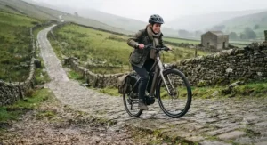 Electric bike struggling on a steep hill to illustrate 36V power limits.