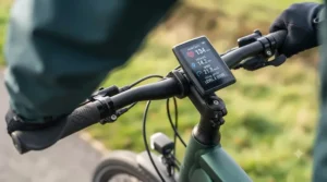 Close-up of an e-bike display showing heart rate and distance metrics for fitness tracking.