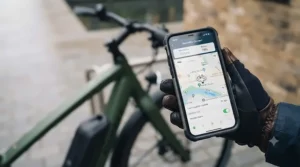 Smartphone display showing GPS anti-theft tracking software for a secure electric bike on a London commute.