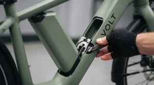 Person easily unlocking and sliding the integrated battery out of the bike frame.