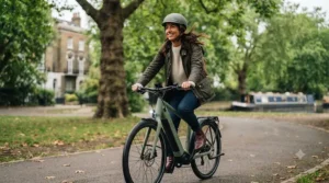 Cyclist riding an integrated battery e-bike through a modern UK city street.