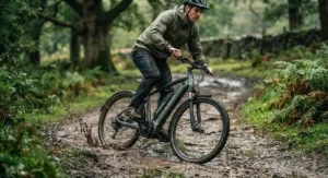 Cyclist navigating a muddy British canal path on an all-weather IP65 electric bike built for year-round riding.