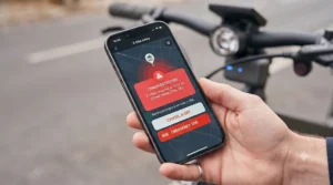 Mobile phone application screen displaying an automated emergency SOS notification triggered by an electric bike crash sensor.