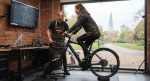 Professional bike fitter using laser alignment tools during an electric bicycle ergonomic assessment in a British cycle shop.