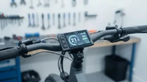 Clear, water-resistant handlebar LCD display on an ebike showing speed and battery level in damp weather.