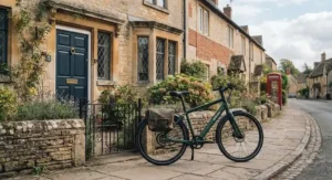 A stylish step-through internal hub gear electric bike parked outside a typical Victorian terraced house.