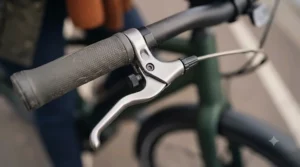Close-up view of an electric bike easy-reach brake lever mechanism showing the customisable adjustment dial.