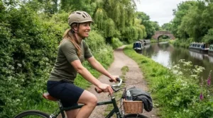 Cyclist enjoying a weekend leisure ride along a British canal path, resting hands comfortably on ergonomic grips.