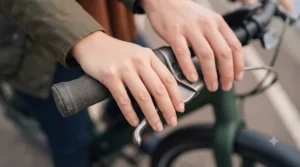 A rider with smaller hands demonstrating a comfortable grip on the electric bike easy-reach brake levers.