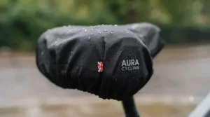 A versatile weatherproof saddle cover fitted snugly over a wide cushioned electric bike saddle.