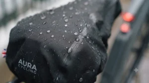 Close-up view of durable, heavy-duty waterproof fabric on an electric bike seat protector shedding rainwater droplets.