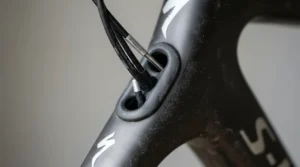 An electric bike drainage frame design highlighting a sealed internal cable routing port preventing moisture ingress.